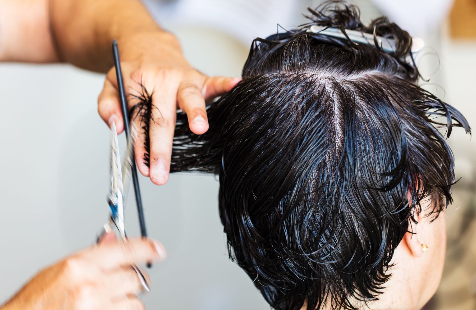 Stylist cutting short dark hair